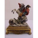 A ceramic figurine of Napoleon on horseback, signed to base mounted on an ormolu base