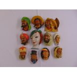 Eleven polychromatic wall masks of various form and style to include Gross