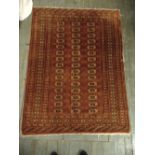 Persian wool carpet red ground with geometric repeating pattern and border, 178 x 133cm