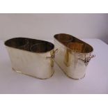 A pair of twin handled silver plated double bottle wine cooler buckets of oval form with pierced