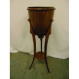 An Edwardian mahogany plant stand of conical form on triform base