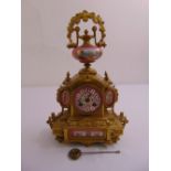 A French 19th century gilded metal and porcelain mantle clock with Roman numerals, two train