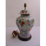 A Chinese porcelain baluster vase decorated with flowers and butterflies, later converted to a table