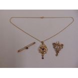 A quantity of 9ct gold to include pendants, a brooch and a chain, approx total weight 10.7g (3)