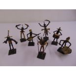 A quantity of West African painted metal tribal musical figurines (7)
