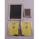 Four silver hallmarked rectangular photograph frames