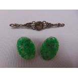 A pair of carved jade earrings and a silver brooch set with a citrine