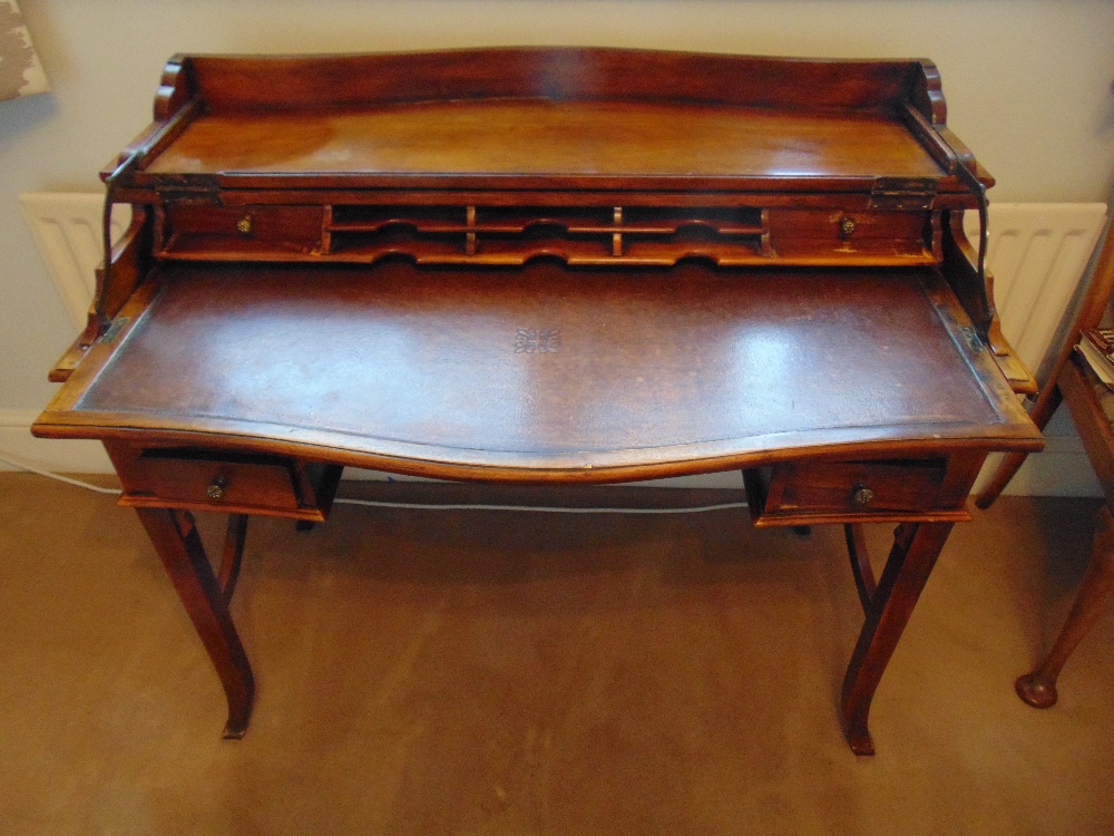 A 19th century rectangular mahogany rise and fall bow fronted desk, the rise and fall mechanism