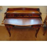 A 19th century rectangular mahogany rise and fall bow fronted desk, the rise and fall mechanism