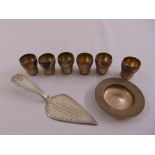 A quantity of silver and white metal to include a presentation trowel and six shot tumblers