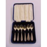 A cased set of ten white metal teaspoons