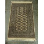 A Persian wool carpet tan ground with repeating geometric pattern and border, 150 x 95cm
