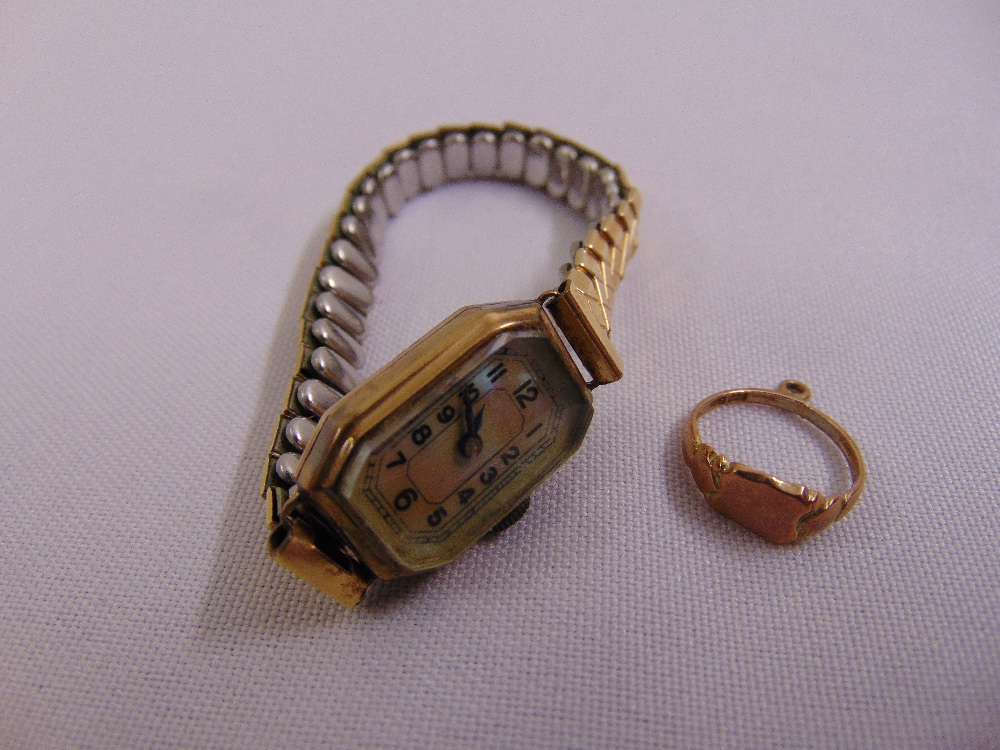 A ladies 9ct gold dress watch with mother of pearl dial and expandable gold plated bracelet and a