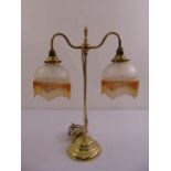 A brass two branch Victorian style table lamp on raised circular base
