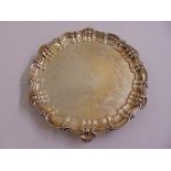 A Victorian silver salver circular engraved with leaves and C scrolls with shell and scroll border