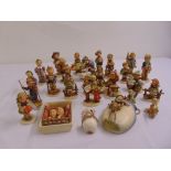 A quantity of Hummel and Goebel figurines and three wall plaques (27)