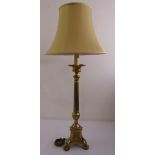 A gilded metal corinthian column lamp stand and silk shade