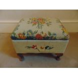 A Victorian upholstered foot stool cum sewing box with accessories on four scroll feet
