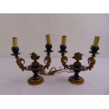 A pair of French enamel and gilded metal two light candelabra converted to electricity