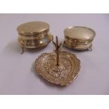 Two silver circular trinket boxes with hinged covers and a silver heart shaped ring stand