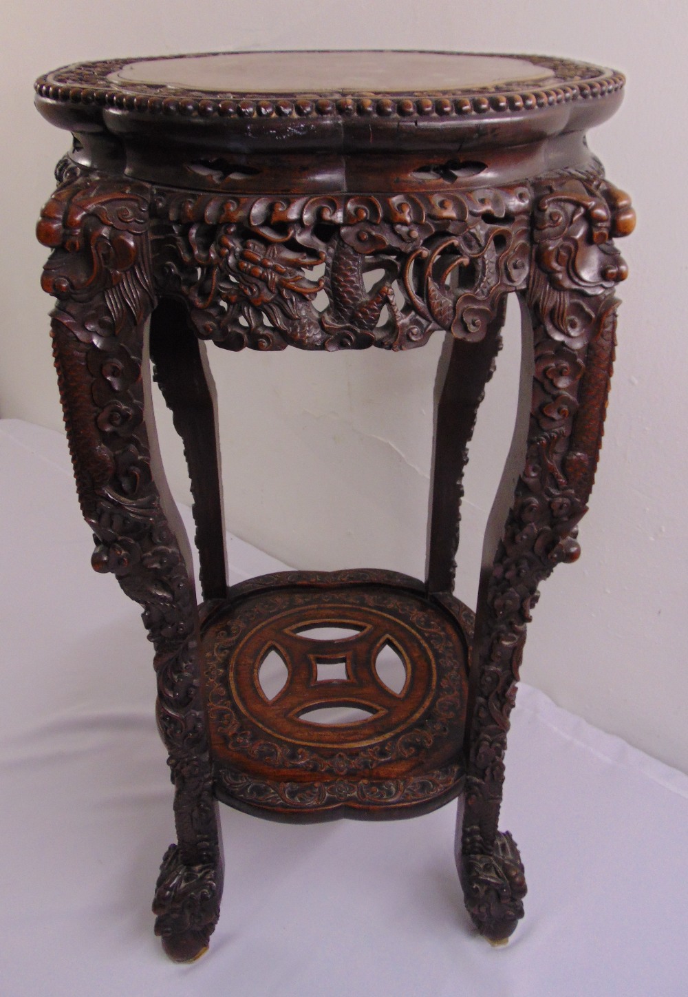 A Chinese 19th century hardwood shaped circular side table with inset marble top the sides and