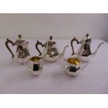 An early 18th century style five piece silver tea and coffee set, panelled pear shaped with domed