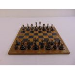 A 20th century carved wooden chess set and board