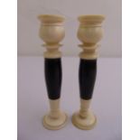 A pair of Art Deco ebony and turned ivory table candlesticks