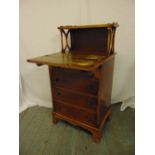 An Edwardian rectangular desk with four drawers, hinged front and gallery shelf