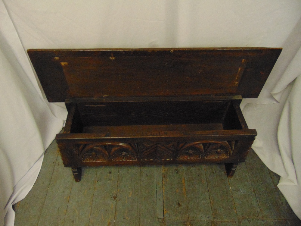 A rectangular oak monks bench with carved sides, hinged cover on four turned legs - Image 2 of 2