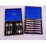 A cased set of silver teaspoons and sugar tongs and a cased set of silver handled tea knives