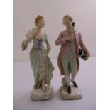 A pair of continental figurines of a gentleman and lady in 18th century costume, marks to the base