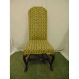 A high back upholstered occasional chair on cabriole legs