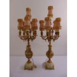 A pair of continental gilded metal and white marble five light candelabra table lamps with silk