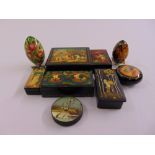 A quantity of Russian papier-mâché hand painted covered boxes and two ornamental eggs (7)