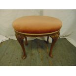 A mahogany upholstered stool on four cabriole legs