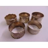 Five silver napkin rings of various form