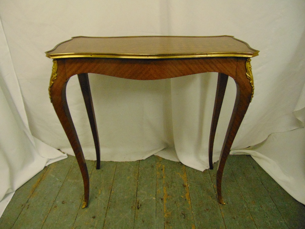 A rectangular Kingswood hall table with applied brass mounts on four cabriole legs