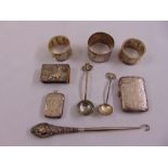 A quantity of silver to include two vesta cases, three napkin rings, condiment spoons and a button