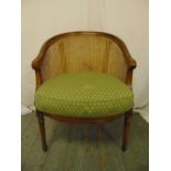 A Victorian occasional chair with bergere cane and upholstered seat on fluted tapering cylindrical