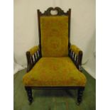 An Edwardian mahogany upholstered armchair, galleried arms on four tuned cylindrical legs