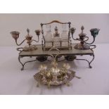 A quantity of silver plate to include a condiment set, candelabra, egg cup stand and a hot tray