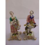 A pair of continental porcelain figurines circa 1885 of a man and lady, gold anchor mark to base
