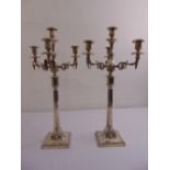 A pair of Victorian neo-classical four light candelabra, fluted tapering cylindrical stems on raised