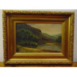 A framed oil on panel of a river and mountain scene, 34.5 x 50.5cm