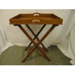 A rectangular wooden butlers tray on articulated stand