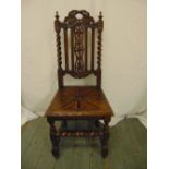 A continental oak hall chair carved and pierced on turned legs