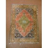 A Persian silk carpet central rosette stylised leaves and vegetation predominantly browns, blues and