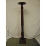 A Victorian mahogany torchere the carved cylindrical column on raised square base