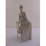 Lladro figurine of a lady standing by a chair and a cat, marks to the base